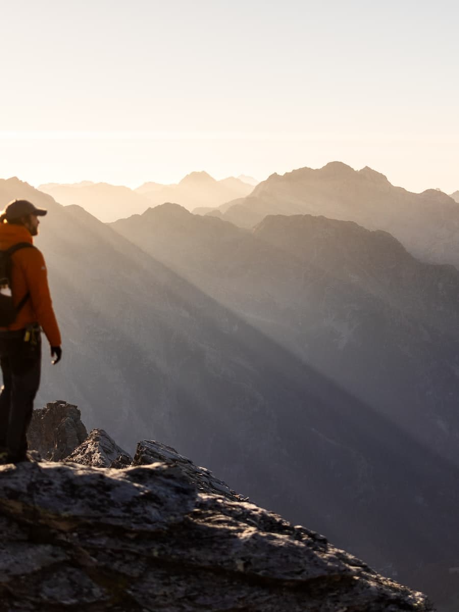 Trekker on a Himalayan ridge at sunrise